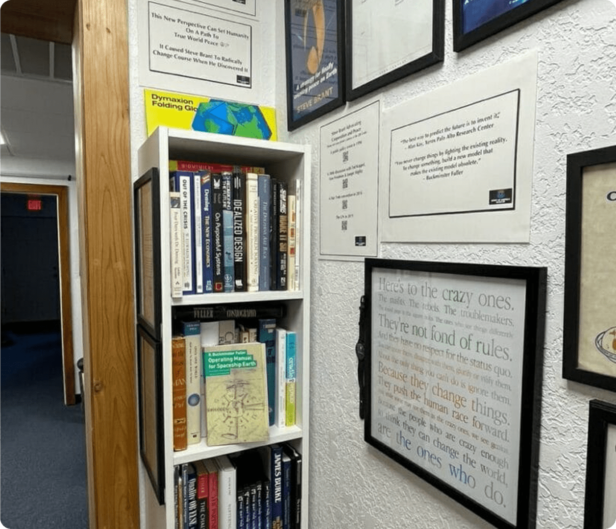 Framed quotes on wall above bookshelf