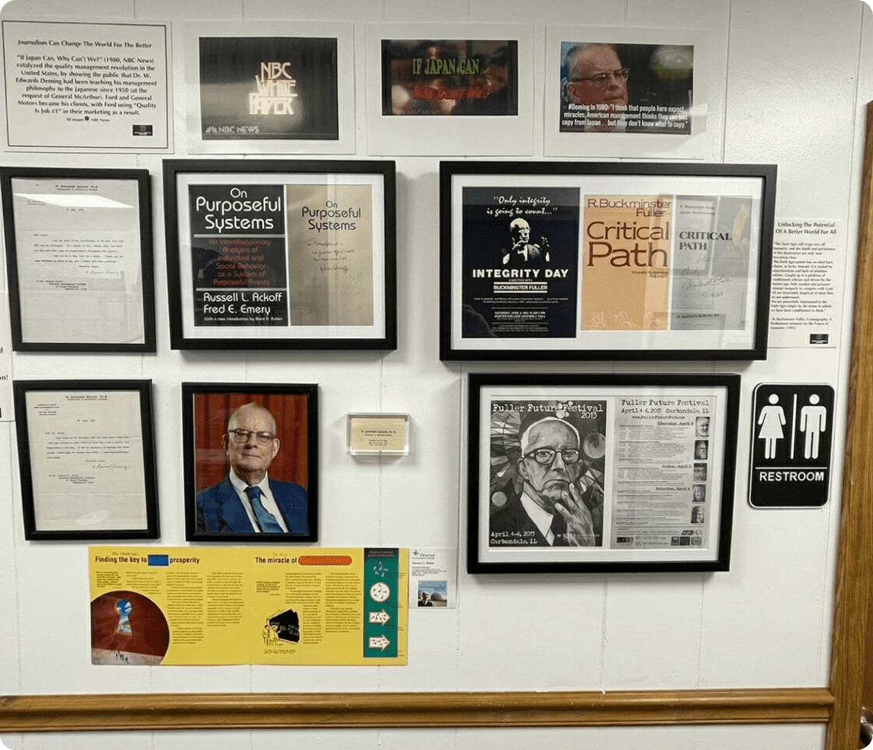 Framed articles and photos on display wall