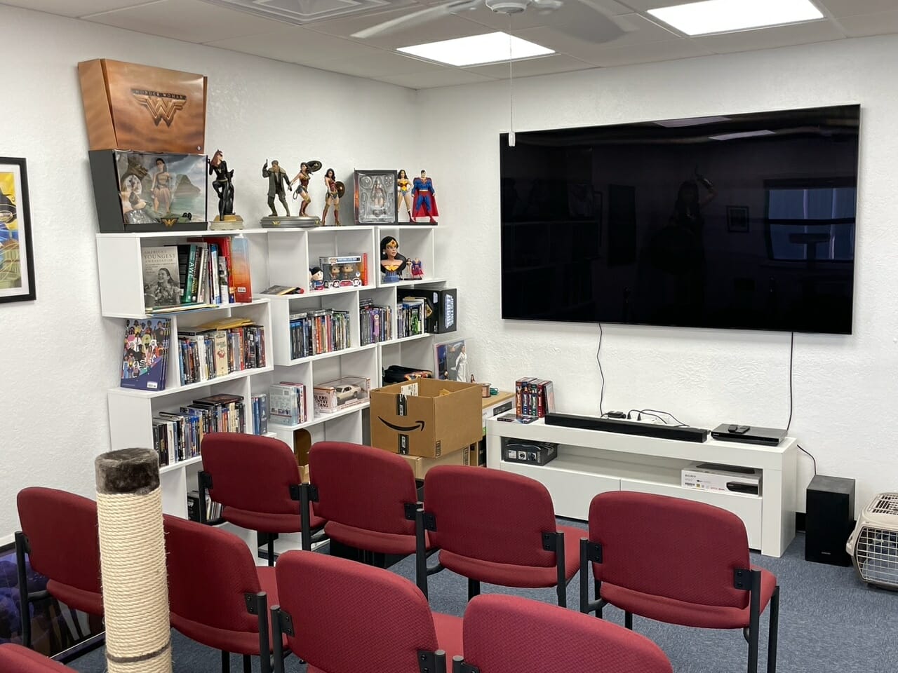Media room with red chairs and large TV