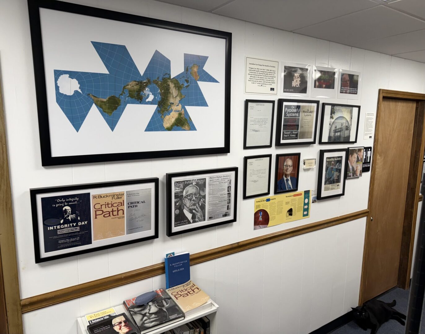 Office wall with framed map and certificates